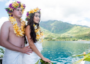 Couple wearing polynesian weeding pareos and flowers